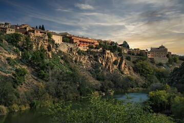 Fototapeta na wymiar Bustling cityscape of modern buildings situated on the edge of a deep canyon in Toledo, Spain