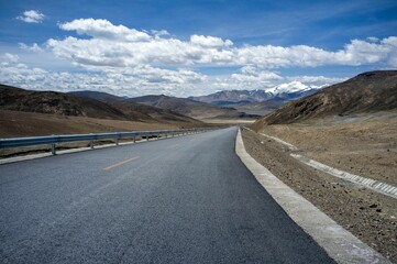Beautiful view of the road against mountains and a cloudy sky