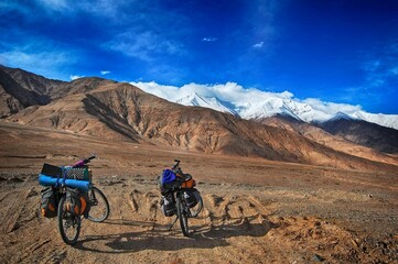 Bicycles with loads against Atlas mountains on a sunny day