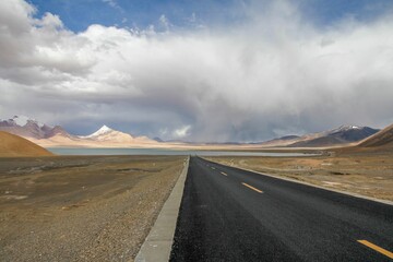 Aerial view of road through desert surrounded by hills