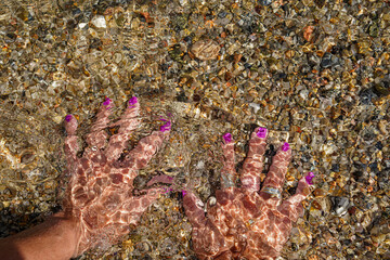 Background of two wet woman legs in the sea in calm vacation. Tranquil scene