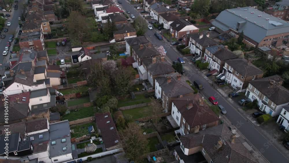 Canvas Prints Drone footage over a town with similar shaped houses and traffic in time lapse