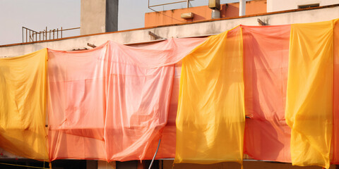 house with colorful cloths and sheets in front of the windows like in the southern part of the world