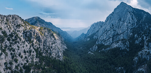 Aerial view of a mountain pass and stormy cyclone clouds in the sky. changeable weather outdoors