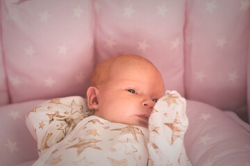 Portrait of adorable baby newborn lying on the bed