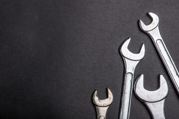 silver wrenches tools on a black background.