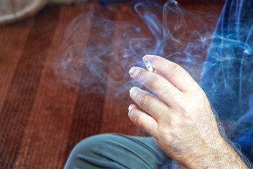 Hand of a man smoking a cigarette