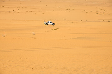 A four wheels car driving trough the desert