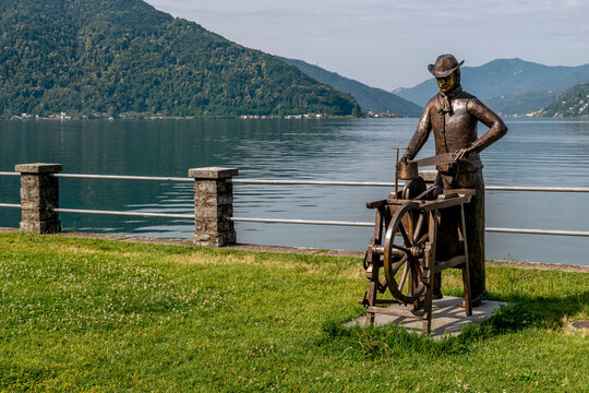 A bronze sculpture depicting a knife grinder on the lakefront of Bissone, Switzerland