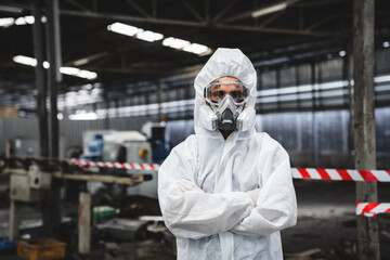 Portrait of Scientist workers wear protection suit checking chemical contaminated oil in old factory. Protecting Against Hazards and Contamination.