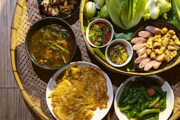 Thai food Northern style (Khan-Toke); spicy minced pork salad, thai sausages, deep fried pork skin, spicy chilly paste and sticky rice etc. Local Thai food in North of Thailand.