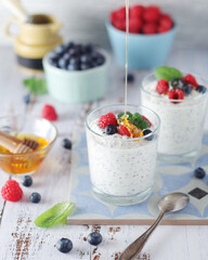 Greek yogurt in glasses with berries and quinoa