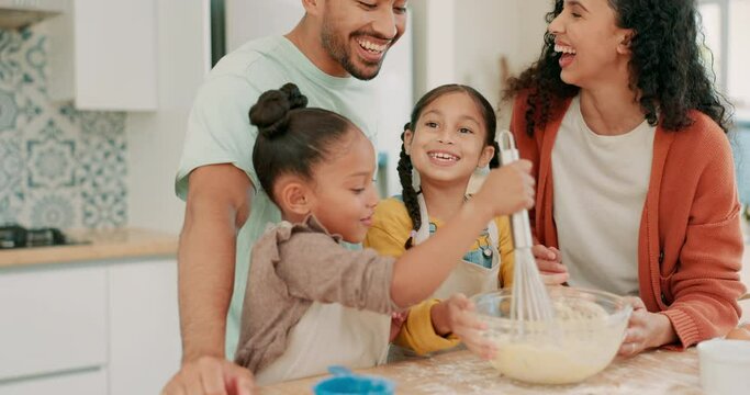 Whisk, bowl and a family baking in the kitchen together with parents teaching their girl children about food. Funny, recipe or bonding with kids learning how to cook from a laughing mother and father