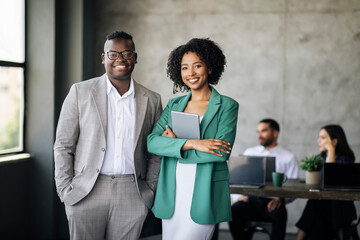 Happy Couple Of Black Coworkers Posing At Modern Office Interior