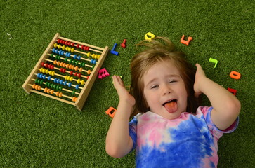 Little boy with colorful abacus learning counting. Kids study and learn. Preschool kid writing and...