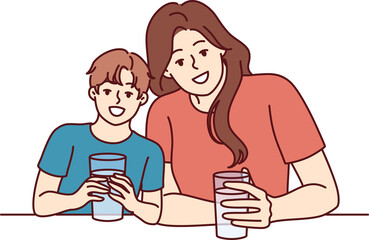 Happy mom and son drink water from transparent glasses and smile enjoying clean refreshing beverage