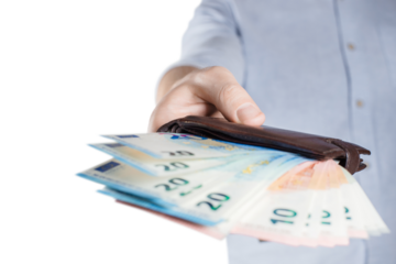 Hand giving a leather purse full of euro banknotes, cut out