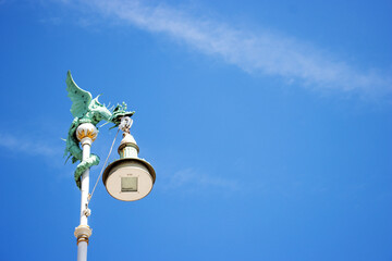 Fototapeta na wymiar traditional dragon lamp post in Copenhagen, Denmark with a clear blue sky