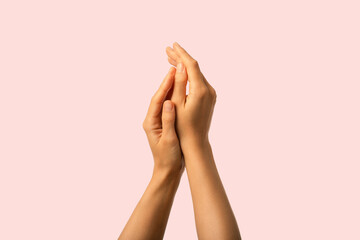 Hands care. Close up of moisturized beauty hands isolated on pink background