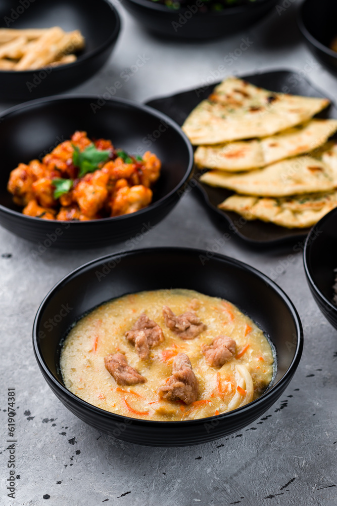 Canvas Prints Soup with noodles and chicken, spicy chicken fillet with chili and Naan flatbread with cilantro.