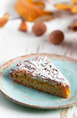 Baked pie served with hot tea on table with dried leaves and walnuts autumn composition