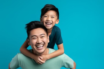 Portrait of happy asian father and son on light blue background. Ai generated.