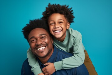 Portrait of a happy african american father and son on blue background. Ai generated.