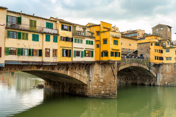 Fototapeta na wymiar A picturesque view of Ponte Vecchio, the oldest bridge in Florence, with the River Arno flowing beneath it
