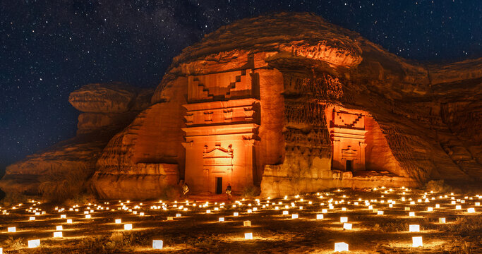 Guarded ancient tombs of nabataean Hegra Mada'in Salih city illuminated during the night, Al Ula, Saudi Arabia