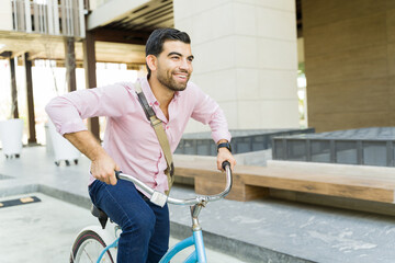 Fototapeta na wymiar Fun young man enjoying his commute using his bike