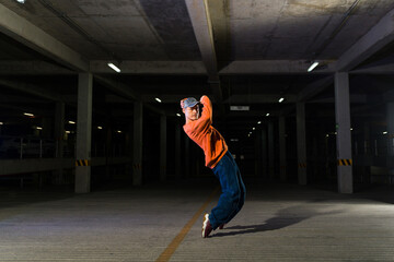 Artistic male street dancer breakdancing at night