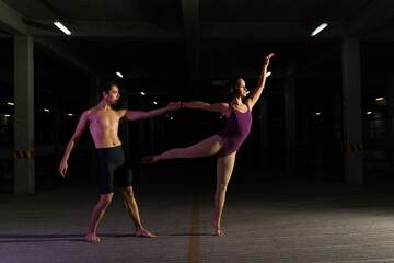 Artistic couple dancing classical ballet at night