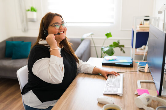 Happy plus size woman working in customer service support