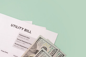 Paper bill with energy and water costs, Utility bill payment for business customers, green background, copy space