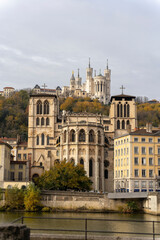 Obraz premium A stunning view of Lyon, France captured from the river, showcasing the iconic Basilica of Notre-Dame de Fourvière perched atop the hill. A beautiful scene that captures the essence of this historic c