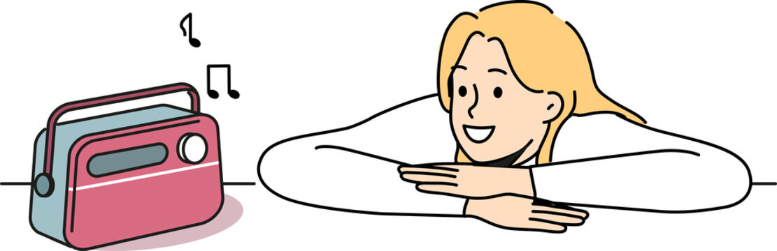 Woman is listening to radio using vintage fm receiver and enjoying analog sound of music