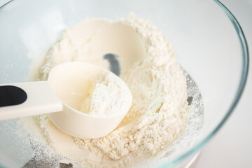 weigh food, flour in a bowl on a digital kitchen scales, dough and pastry preparation
