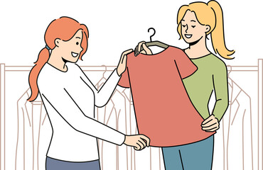 Fototapeta premium Smiling consultant help client with clothes choice