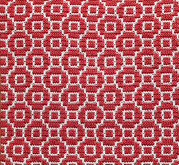 Abstact knitted background. Crochet mosaic pattern. Seamless red white crochet texture.