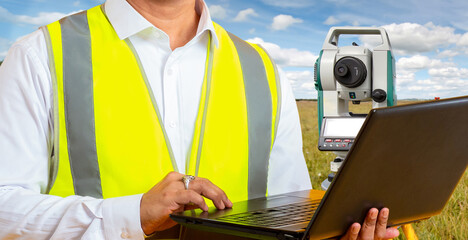 Surveyor with laptop. Geodetic technologies. Cropped male surveyor. Optical theodolite in field. Use of software for geodesy. Equipment for cartographic works. Geodetic survey services