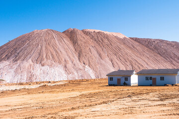 small houses for workers against the backdrop of salt rocks