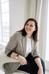 Fototapeta premium Career as a psychologist, sitting in a chair office day workplace, cheerful smart manager woman, freelancer working at home.