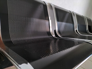 Selective focus. Stainless steel waiting chair that has started to rust in front of the meeting room.
