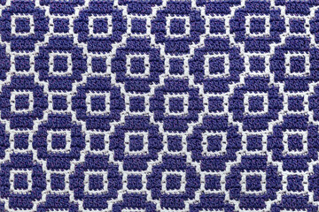 Abstact knitted background. Crochet mosaic pattern. Seamless blue white crochet texture.