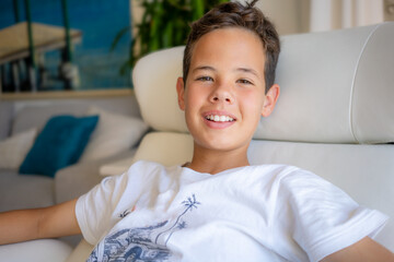 Happy childhood. Close up portrait of cheerful boy smiling to camera