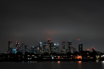 London Skyline skyscrapers at night behind the River Thames, view from Greenwich
