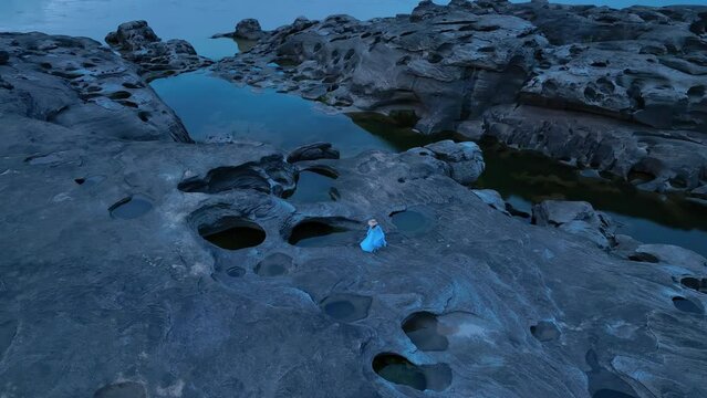 Drone view, Aerial view of Sam Phan Bok, Thailand.and a woman wearing a blue dress