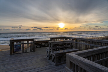 Fototapeta na wymiar Wooden Benches Overlooking the East Coast Beach Sunrise