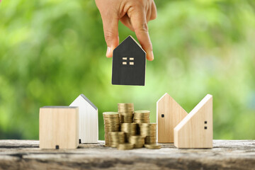 Successful Home Loan Investment with Hand Holding Coins on Nature Background - Wealth and Growth...