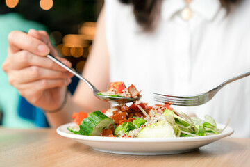 Woman eating green healthy tasty eco salad.  Diet food